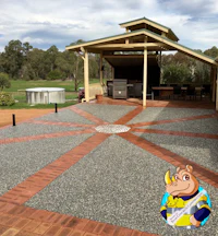 a patio with a grill and a fireplace