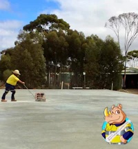 a man is working on a concrete driveway with a bulldozer